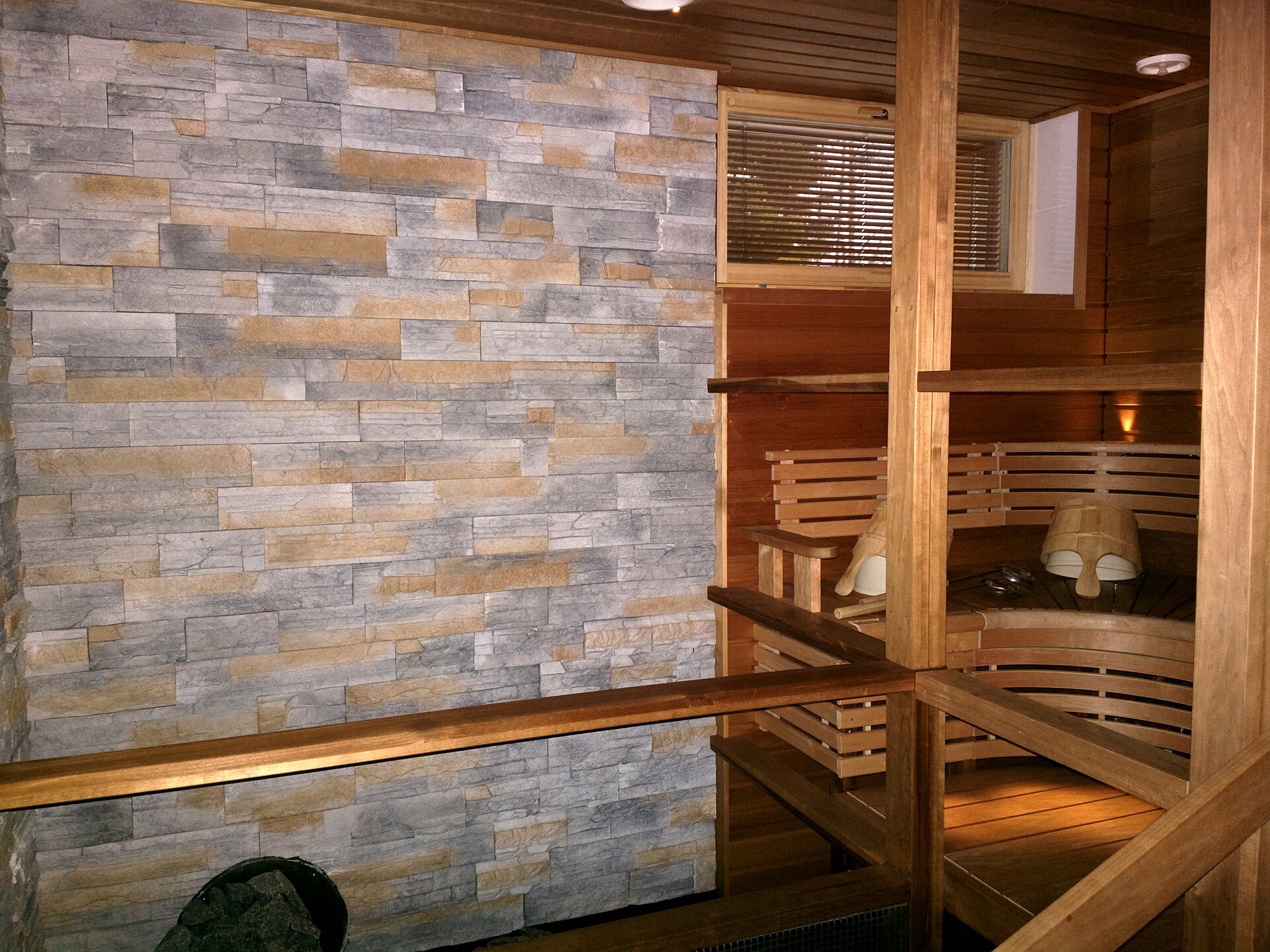 Traditional Finnish sauna with iron stove and stones