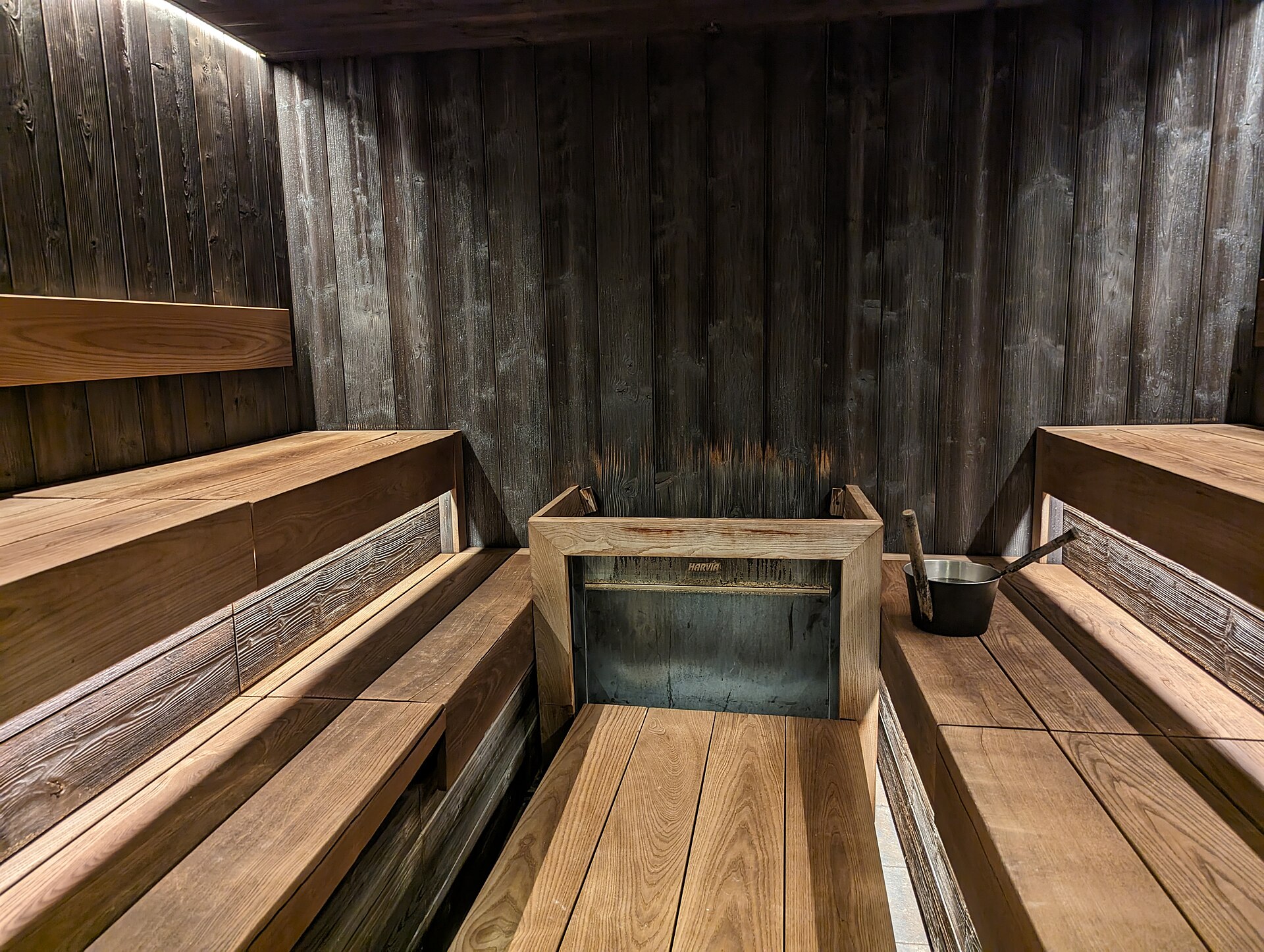 Quiet wood-paneled sauna room with tiered benches