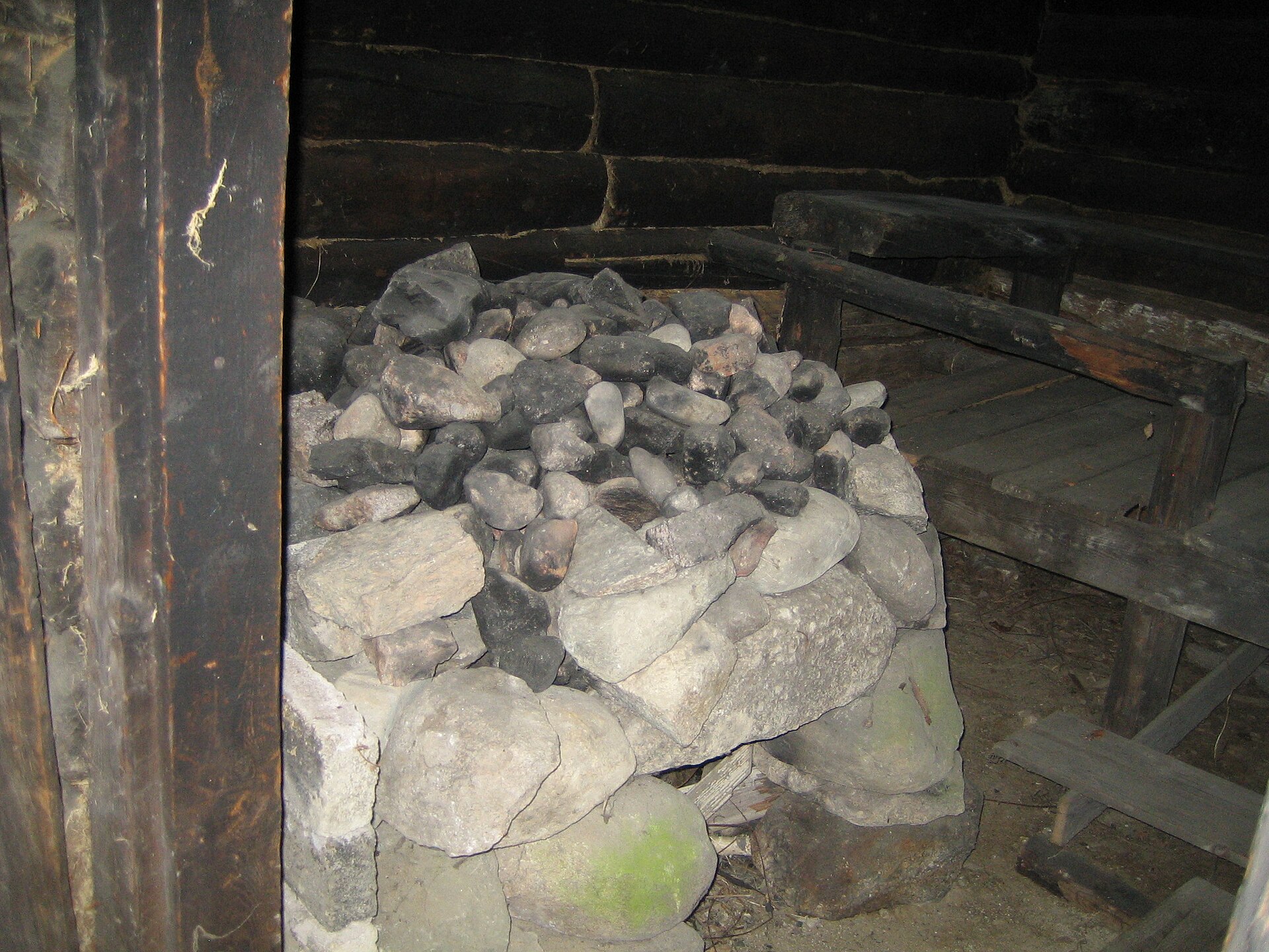 Closeup of a traditional smoke-sauna stove with rocks